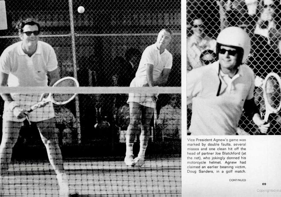 Joe puts his motorcycle helmet on to protect himself from VP Agnew, who had just landed a serve on the back of his head!