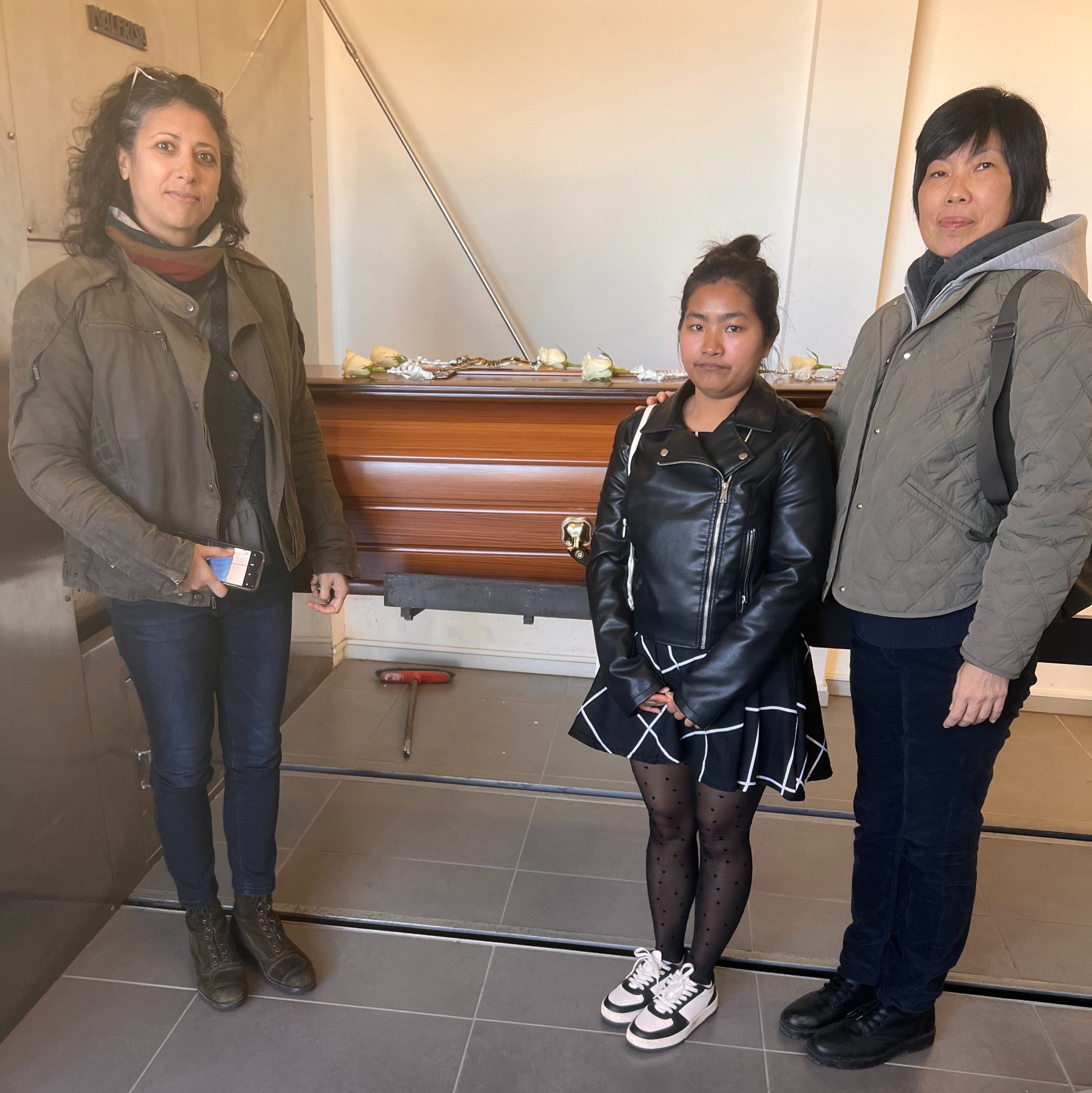 Catarina, Ruby, and I beside Mum’s casket.