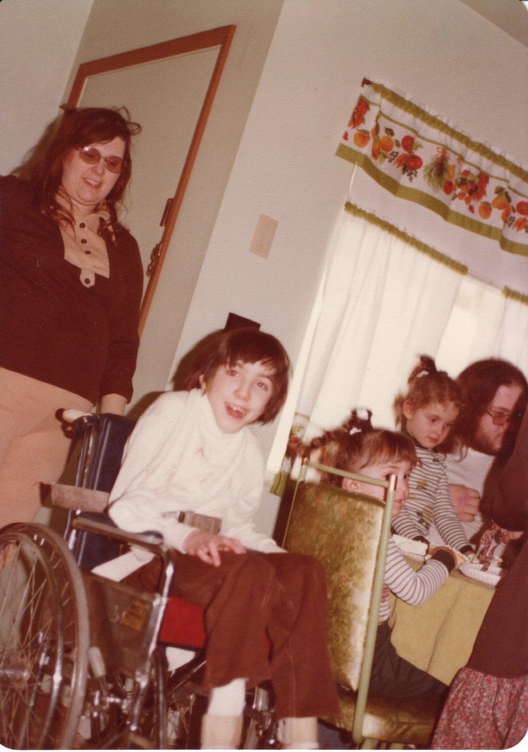 This picture was taken at Grandma Norton's house, in about . you can see Sue by the door, Jon in the wheelchair, me on the chair next to him, and Danielle by the window. 