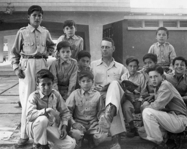 Hernicio (standing left) along side classmates