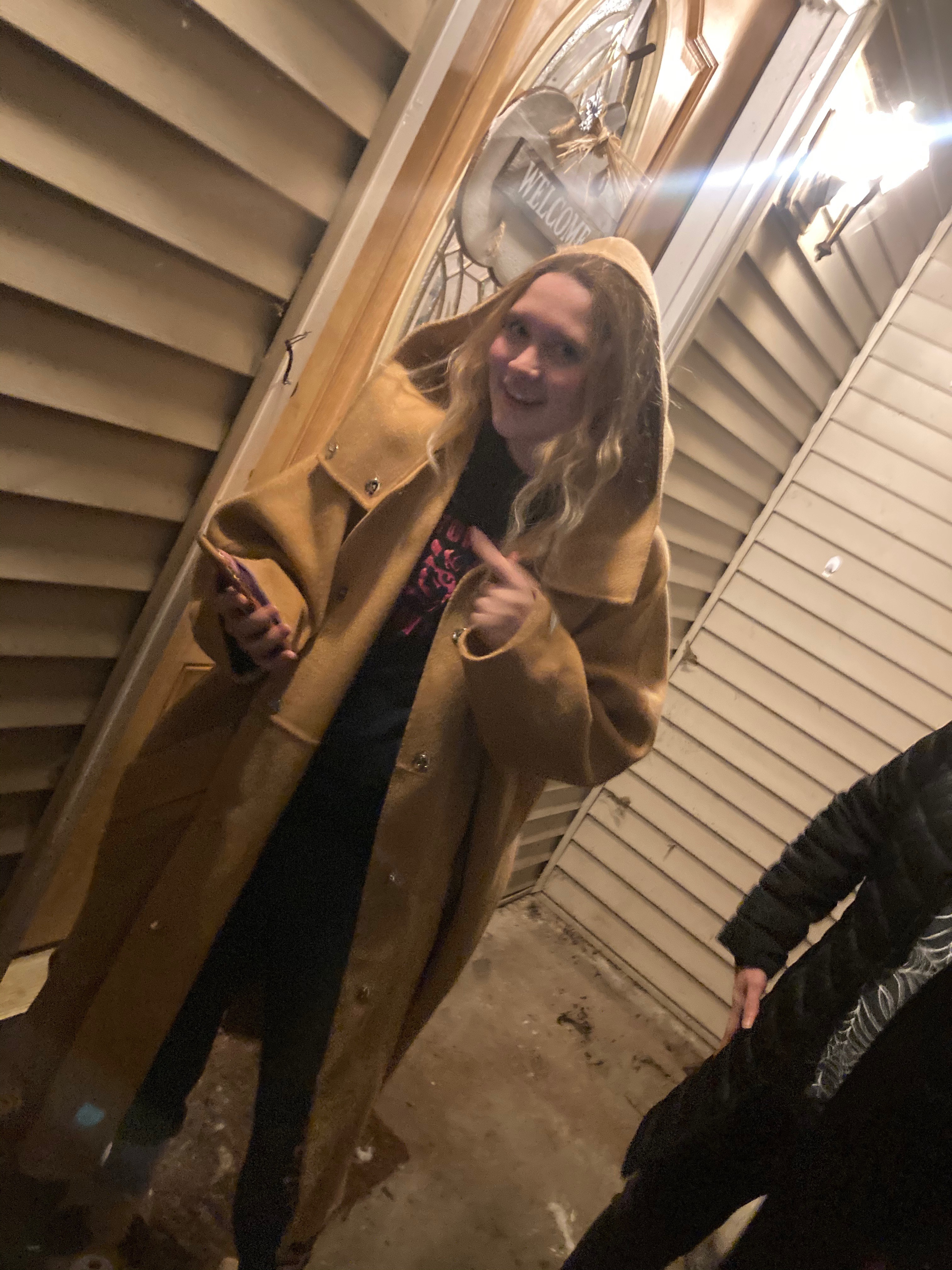 Amanda trying on a giant coat that fits nobody in the house