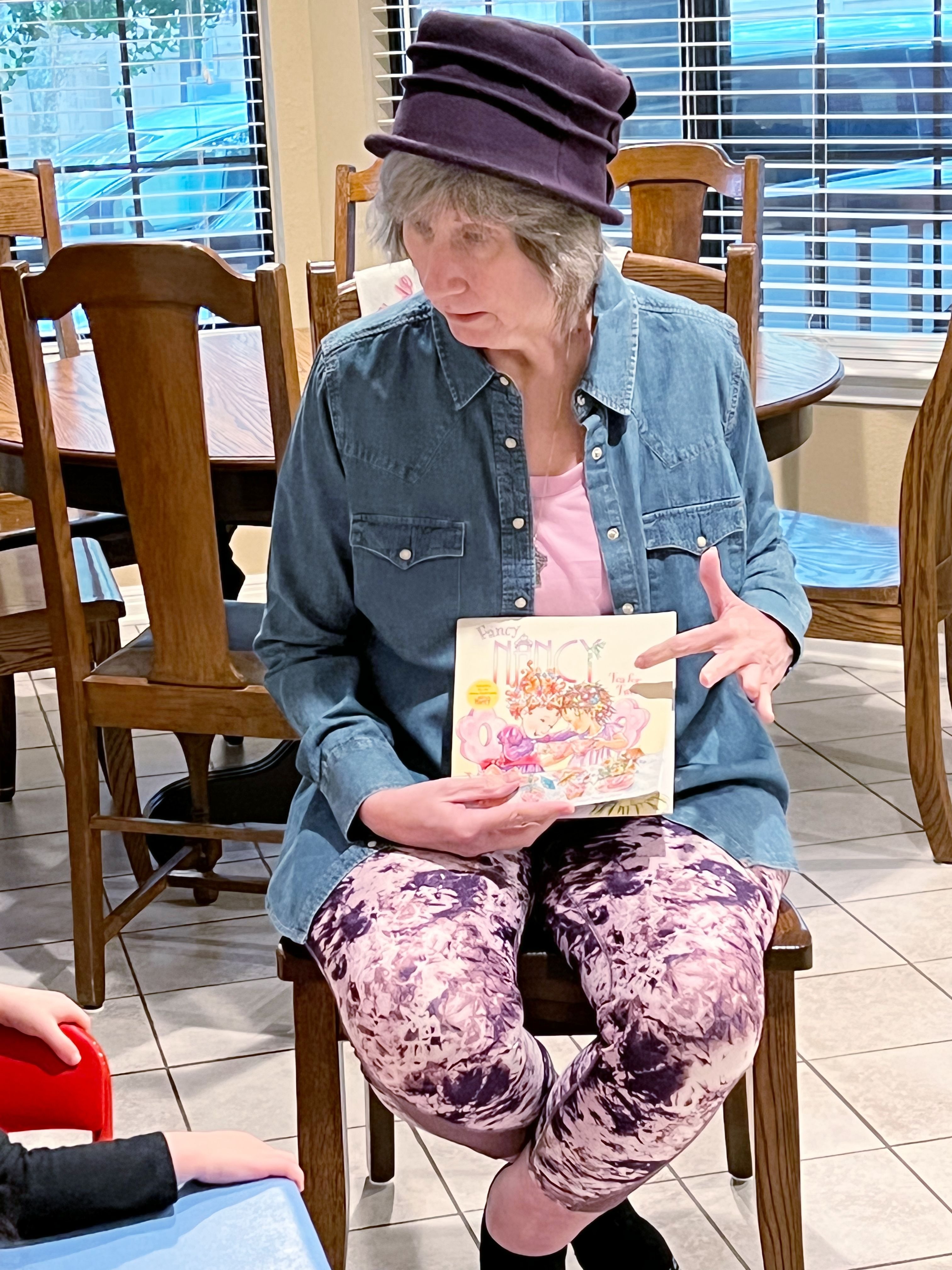 Pam is reading a story about a tea party to Wren and Ariana, San Antonio, Texas, November 2022