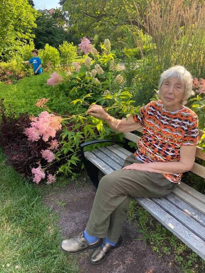 Maina Lopotukhin sitting on the bench in the botanical garden in Flushing, Queens, New York City.