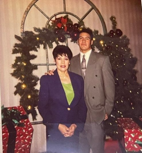 Gloria and her son Carlos at a holiday party