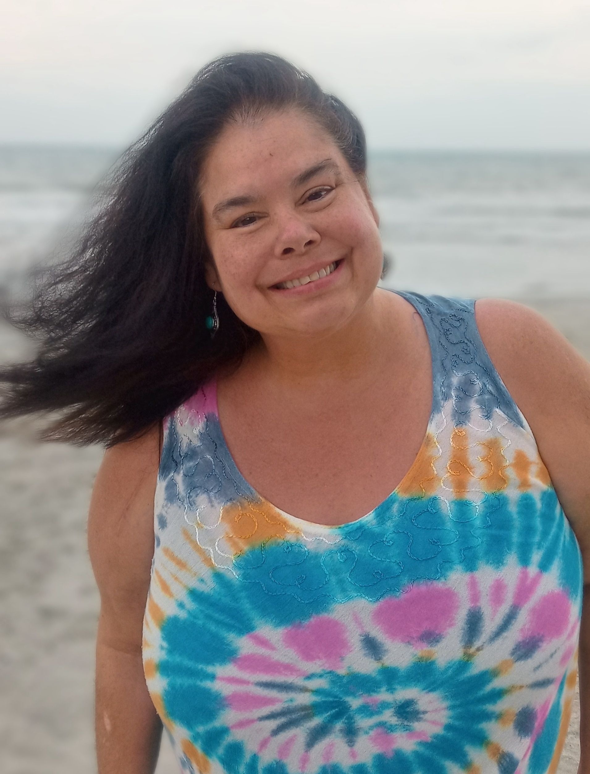 She enjoyed having her toes in the sand walking on the beach.