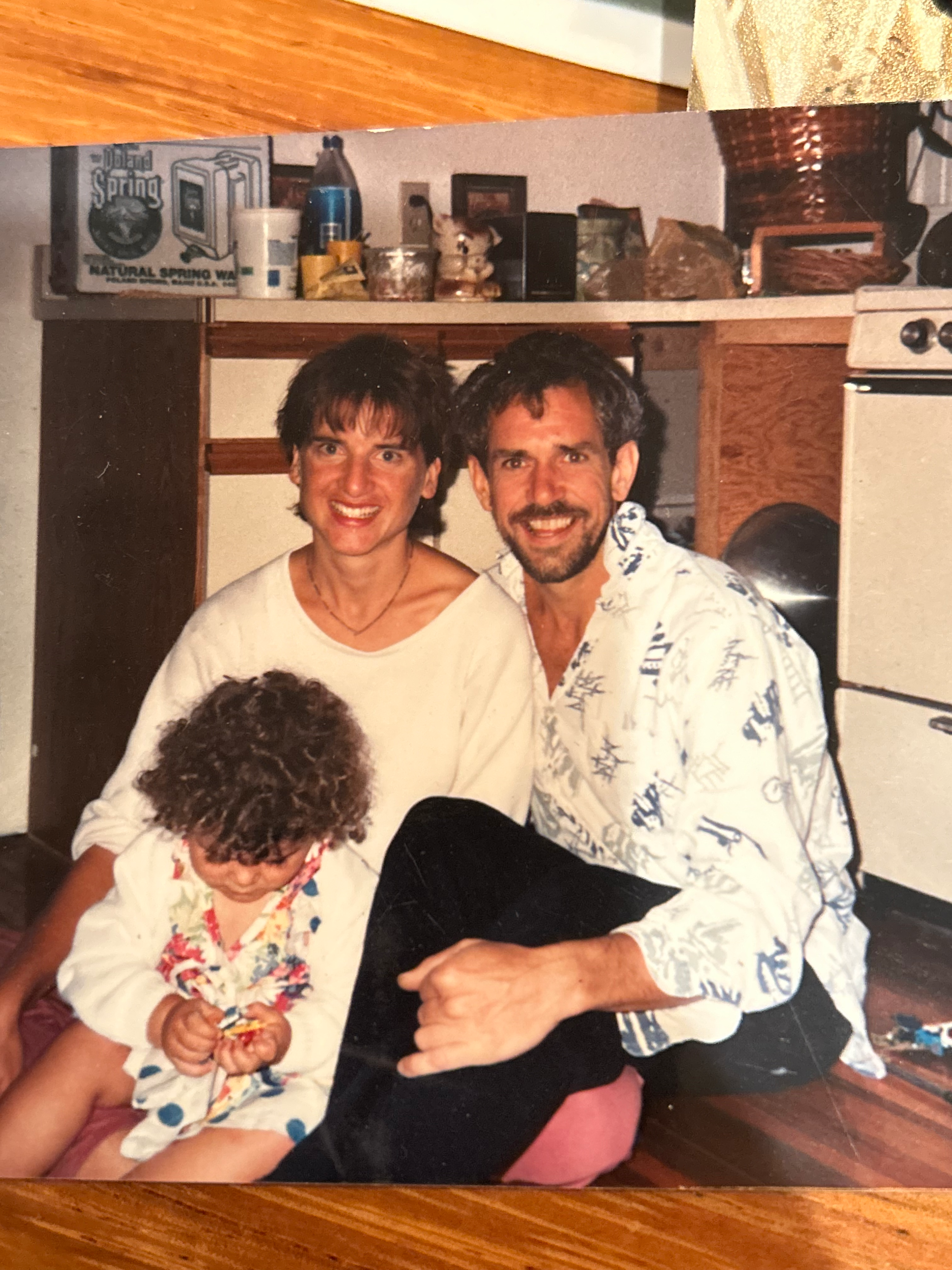 My dad was my biggest hero. He taught me so many things about life and living. He taught me the skill of carpentry. He taught me how to be a musician and audio engineer. He taught me the value of hard work. The value of living healthy. The value of family and community. The value of finding humor in every situation. The value of seeing the goodness in everyone. He taught me how to be a good man, not just in strength but in gentle kindness.
He had the biggest, warm energy and always greeted people with enthusiasm and excitement. His smile was infectious. He loved to share stories of his adventures, which tended to gain more embellishments at each telling. He loved his wife and kids immensely, and was so proud to have met his first grandchild.
In addition to mourning him, I also mourn the music and bands we played in together. From world beat band Bongoville, to Indian devotional music, to bringing back the acoustic Bijou Link songs, to the touring reggae band The Wicked Hangin Chads (later, The Indelibles), and numerous other projects. We spent thousands of hours together in rigorous rehearsals and recording sessions, where my dad would push all the players to perform at their absolute best. He knew what we were all capable of and had a clear vision of what the music should sound like. Then when we would get on stage all we had to focus on was locking in and having fun.
Dad was tenacious and knew what he wanted. And was unapologetic about following his dreams. Once he had his mind set on doing something it was very hard to deter him. He always talked about taking the reggae band on tour to the west coast. And he did, twice. He always talked about fully renovating our childhood home and selling it. And he did, almost singlehandedly. He always dreamed of moving out to the west coast, buying a property with land, and building a stage on it to perform on. He did just that. That drive to reach for those dreams, against difficult odds but with a bit of divine luck, was so inspiring to me.
He’s not here in the flesh anymore. And that makes me grieve for all the future memories I hoped to make with him. But I know he’s with me in my heart, in the hearts of all those he touched. That big, warm energy can live on through us. The qualities of tenacity, humor, enthusiasm, zest for life, kindness, optimism, and overflowing love for family and friends are lessons we can all take with us into the future. That’s what he would want. He would want us to keep spreading the love, making music and magic, keep dancing and making memories with those we love. I know he’s up there, playing a celestial stratocaster, smiling down on us. Fly on Papa, we love you!