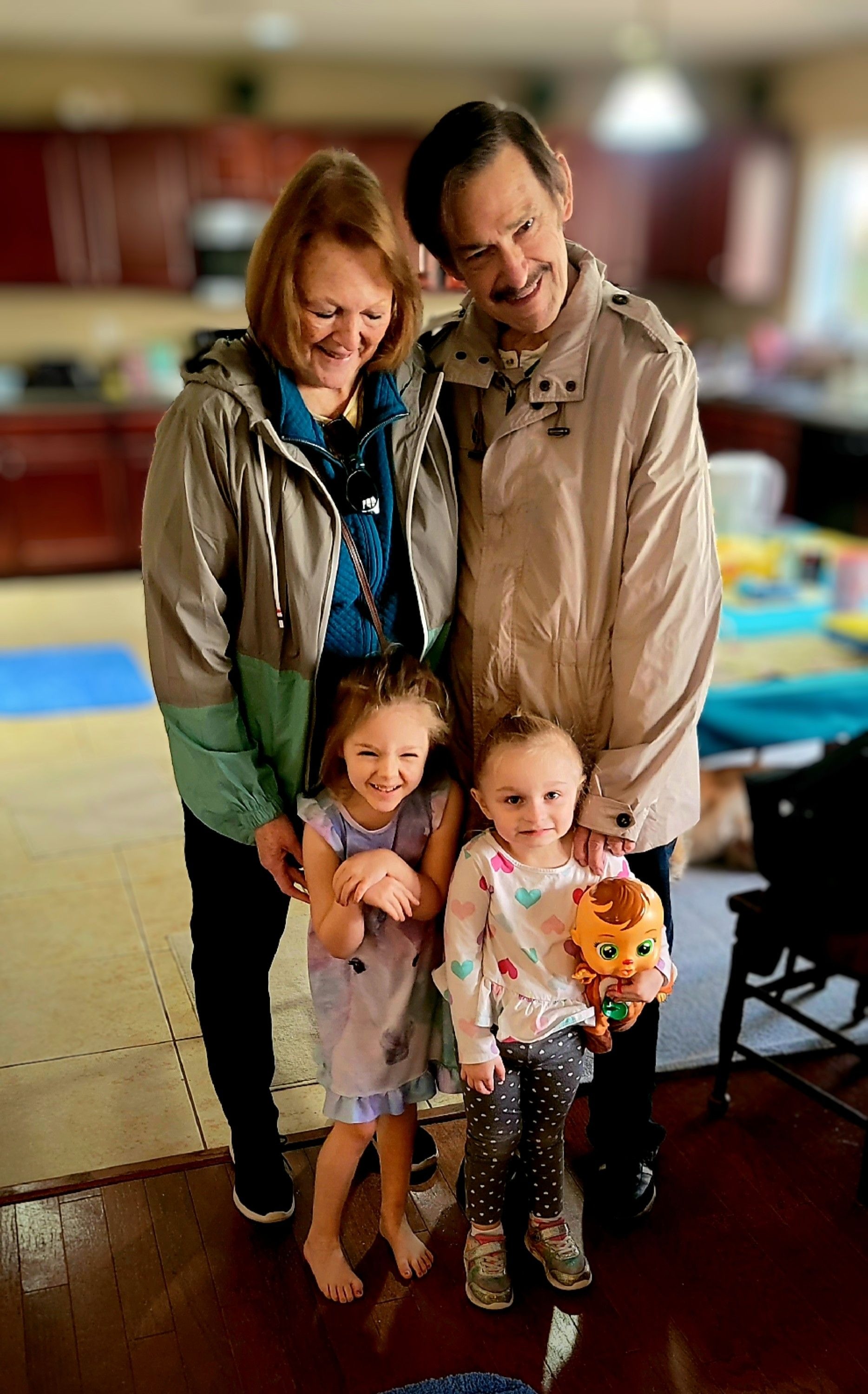 Bob, a.k.a. "Poops", and Brenda having fun with grandchildren Lucy and Brie.