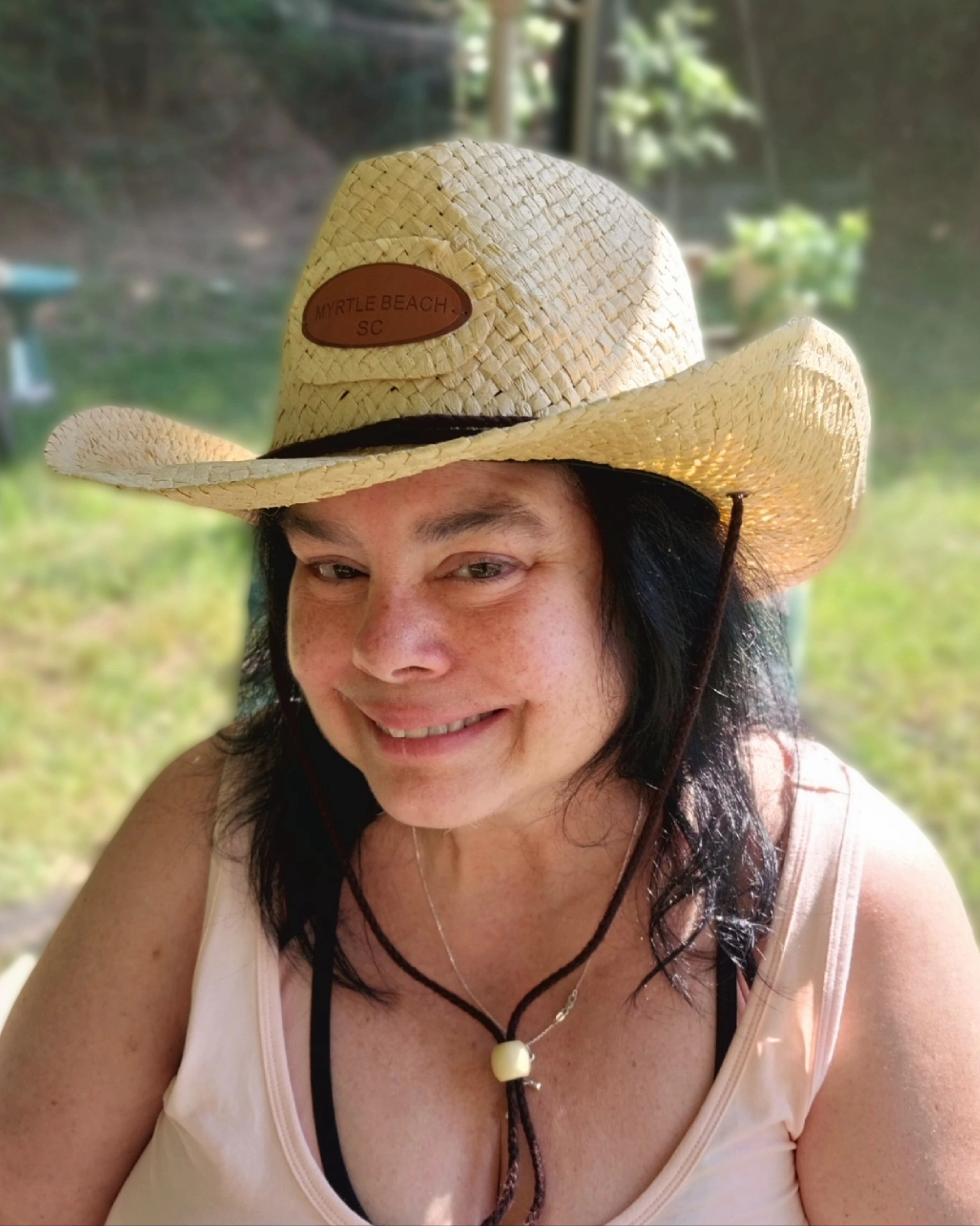 I always told Elizabeth she looked great in hats. I love this photo of here wearing a hat we bought at the beach. This is in our back yard on a sunny summer day.