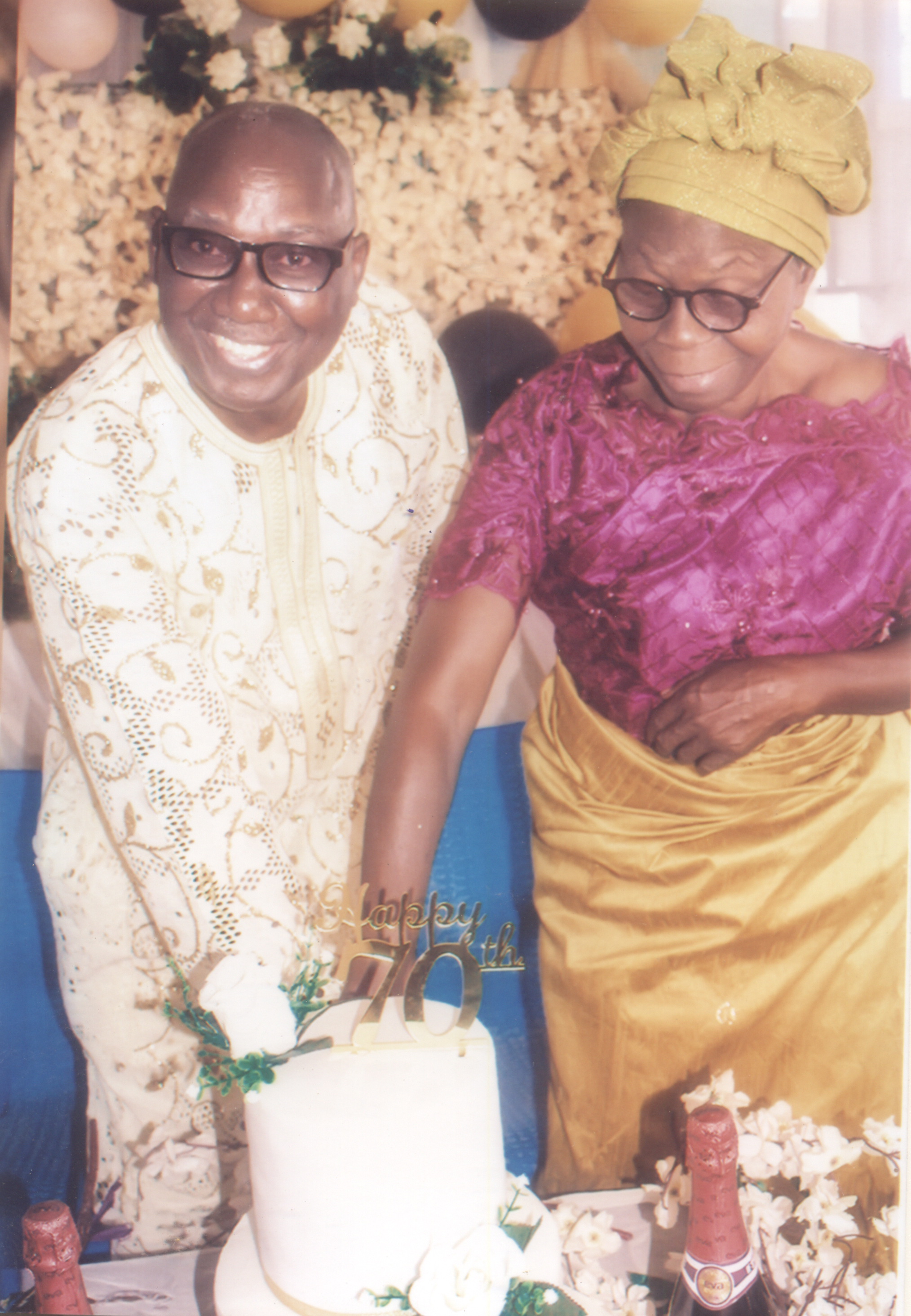 Mama is joining her darling husband in cutting his 70th Birthday cake. What a pleasant moment.