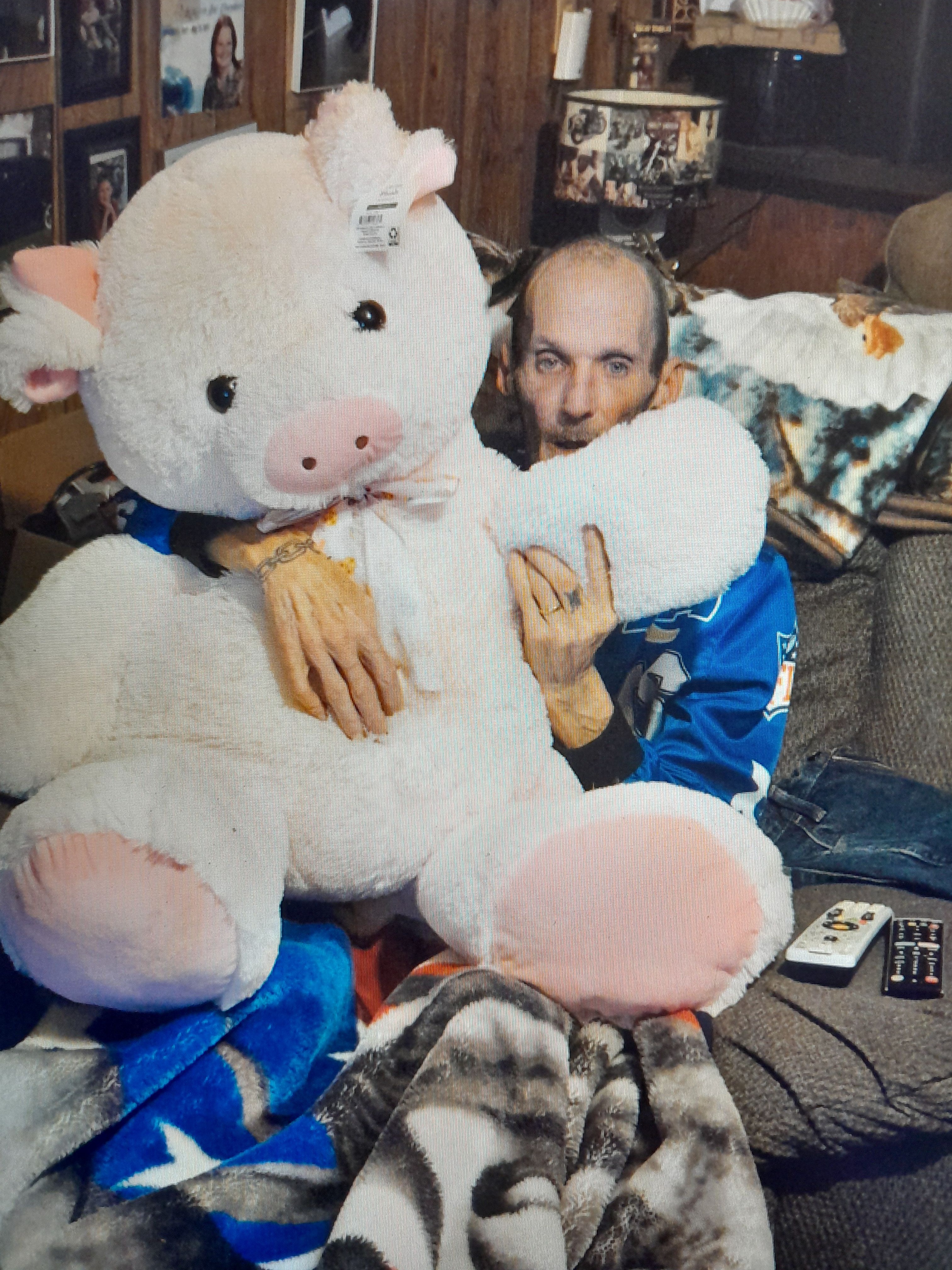 Trying to get bill to hold this pig. It was so funny.  An we were having  fun doing it.     Love misses u so much