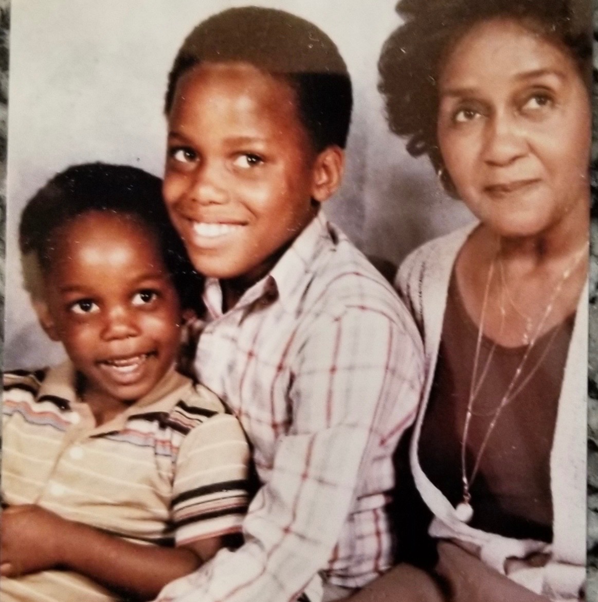 A loving photo of Ernest with his grandmother, Mama Hazel, and his little brother, James.