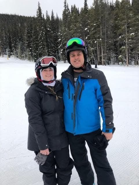 Dad teaching Kayla how to ski.