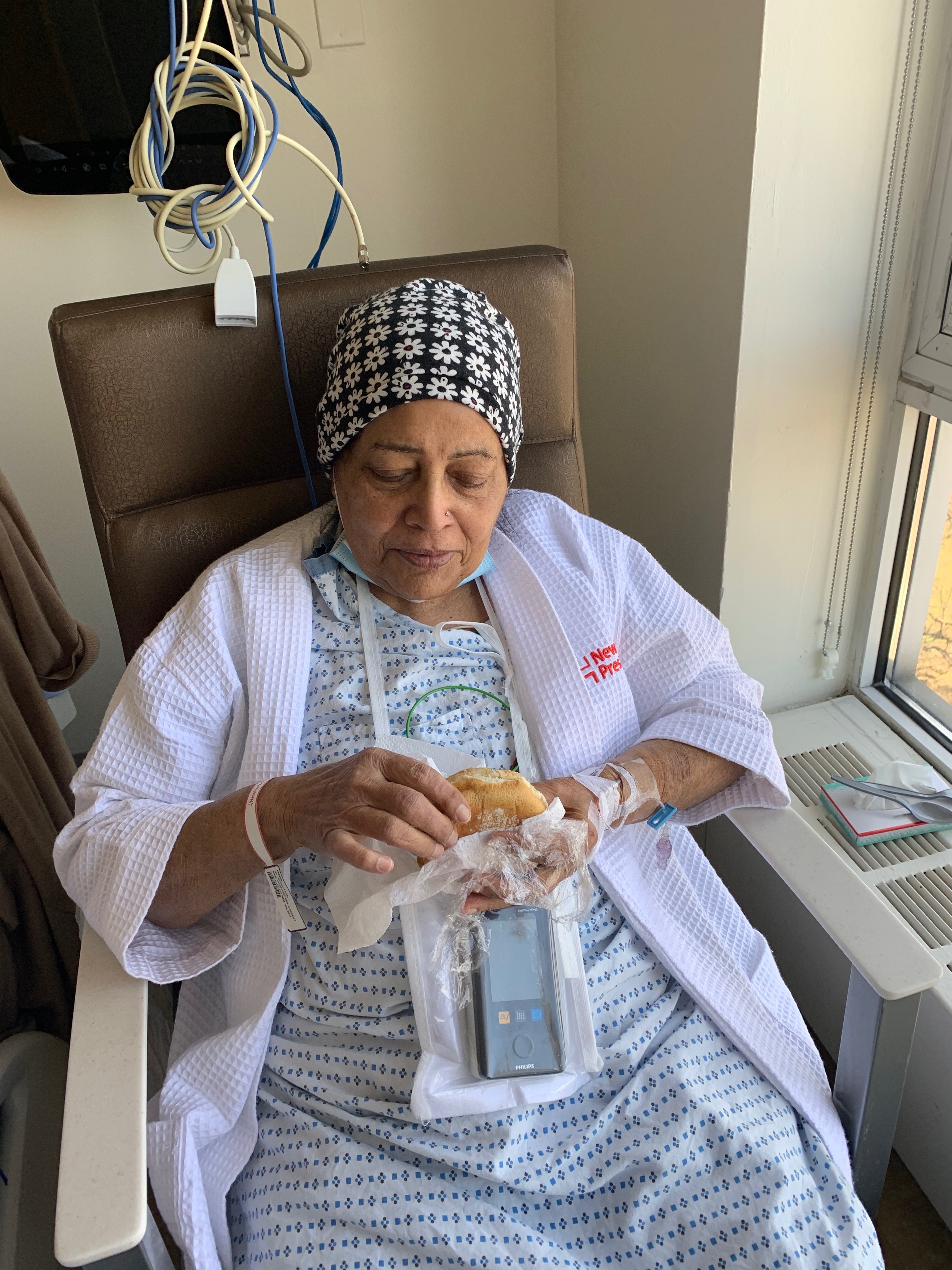Enjoying her bagel with onion and chive cream cheese at the hospital