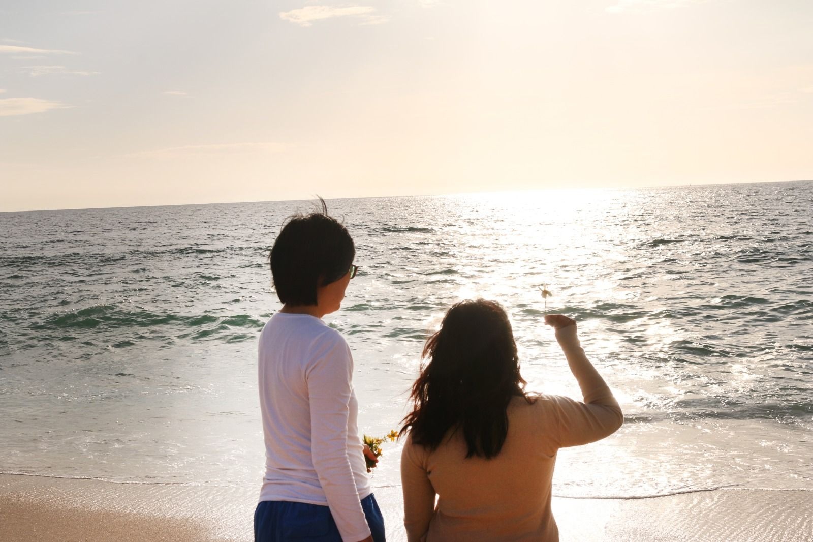 After the farewell — Ruby and I at the edge of the Atlantic, offering wildflowers in Mum’s memory.