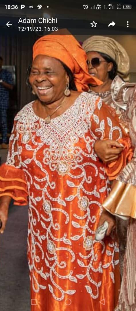 Mama beaming with smiles at her granddaughter's wedding ceremony in Abuja.
