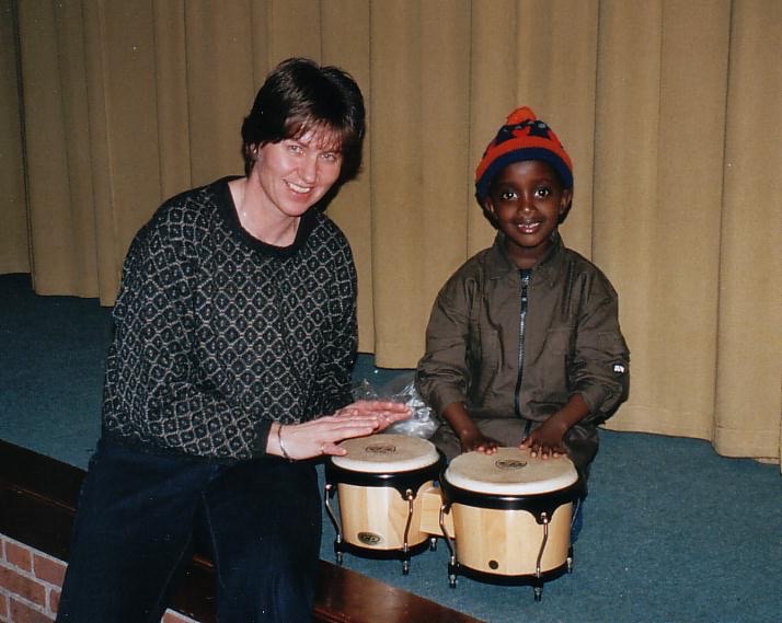 Prince teaching me to play drums at YWAM Heidebeek, 2002.