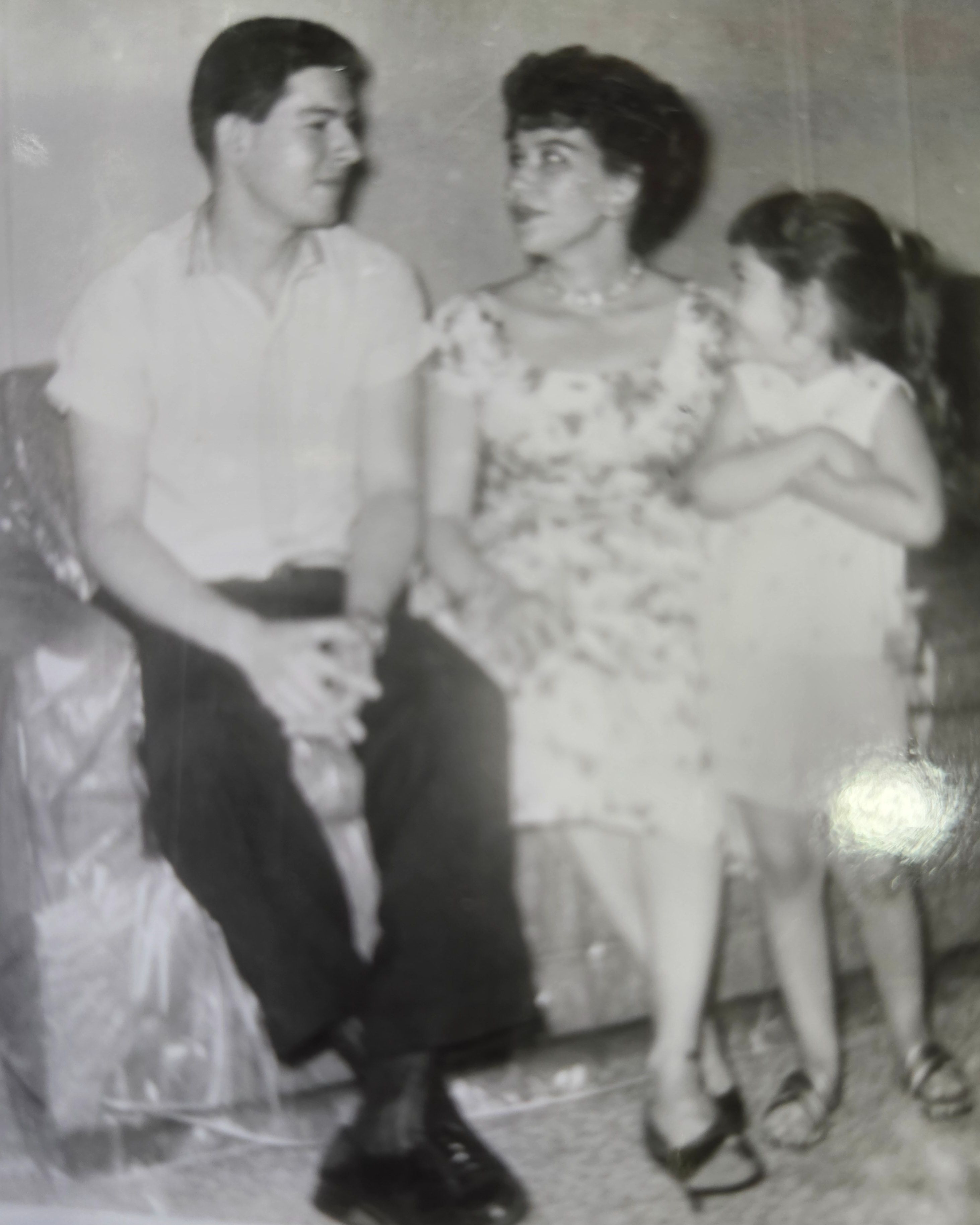 New York City, summer of 1961 in our apartment with plastic on the sofa. A very young Carlos and very handsome, Tia Nena, and Leti.