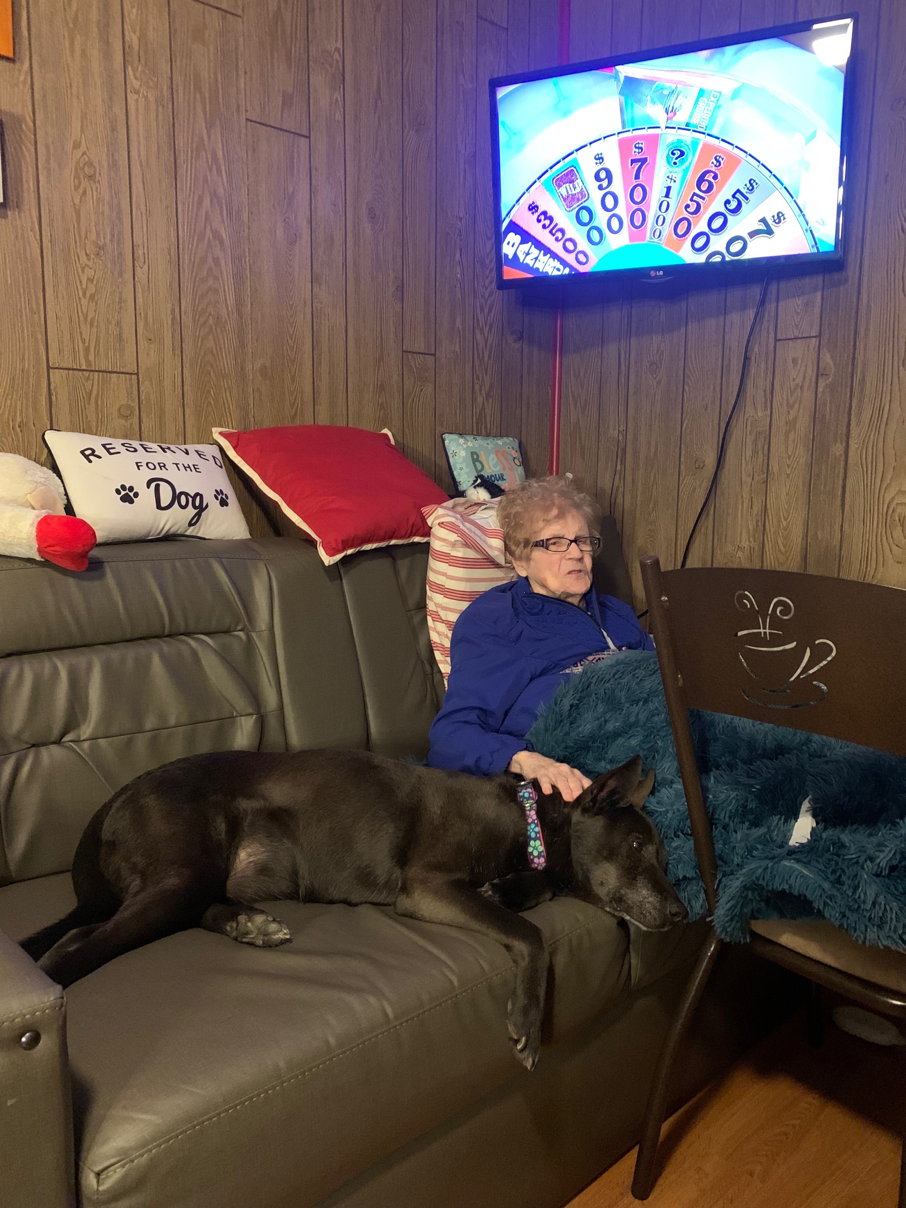 Listening to one of her favorite shows and petting on her grand dog Ellie