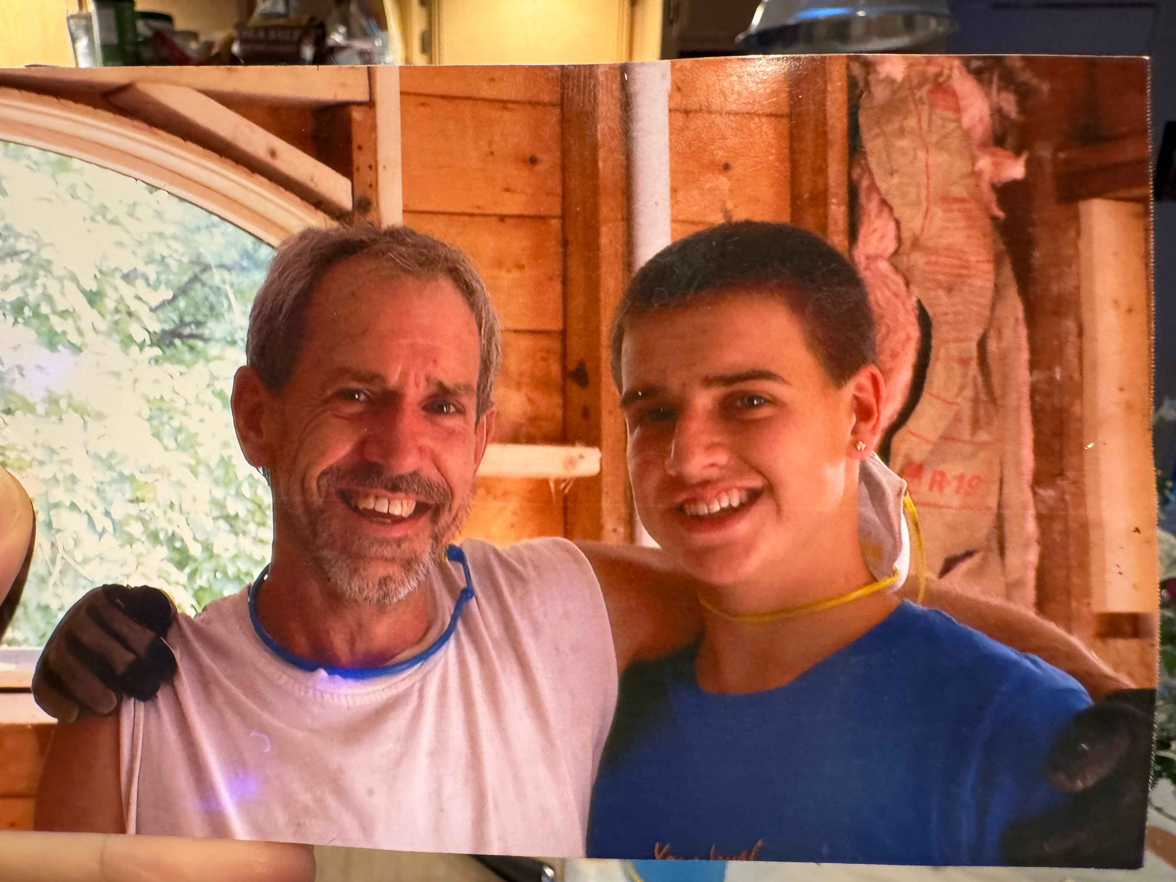 My dad was my biggest hero. He taught me so many things about life and living. He taught me the skill of carpentry. He taught me how to be a musician and audio engineer. He taught me the value of hard work. The value of living healthy. The value of family and community. The value of finding humor in every situation. The value of seeing the goodness in everyone. He taught me how to be a good man, not just in strength but in gentle kindness.
He had the biggest, warm energy and always greeted people with enthusiasm and excitement. His smile was infectious. He loved to share stories of his adventures, which tended to gain more embellishments at each telling. He loved his wife and kids immensely, and was so proud to have met his first grandchild.
In addition to mourning him, I also mourn the music and bands we played in together. From world beat band Bongoville, to Indian devotional music, to bringing back the acoustic Bijou Link songs, to the touring reggae band The Wicked Hangin Chads (later, The Indelibles), and numerous other projects. We spent thousands of hours together in rigorous rehearsals and recording sessions, where my dad would push all the players to perform at their absolute best. He knew what we were all capable of and had a clear vision of what the music should sound like. Then when we would get on stage all we had to focus on was locking in and having fun.
Dad was tenacious and knew what he wanted. And was unapologetic about following his dreams. Once he had his mind set on doing something it was very hard to deter him. He always talked about taking the reggae band on tour to the west coast. And he did, twice. He always talked about fully renovating our childhood home and selling it. And he did, almost singlehandedly. He always dreamed of moving out to the west coast, buying a property with land, and building a stage on it to perform on. He did just that. That drive to reach for those dreams, against difficult odds but with a bit of divine luck, was so inspiring to me.
He’s not here in the flesh anymore. And that makes me grieve for all the future memories I hoped to make with him. But I know he’s with me in my heart, in the hearts of all those he touched. That big, warm energy can live on through us. The qualities of tenacity, humor, enthusiasm, zest for life, kindness, optimism, and overflowing love for family and friends are lessons we can all take with us into the future. That’s what he would want. He would want us to keep spreading the love, making music and magic, keep dancing and making memories with those we love. I know he’s up there, playing a celestial stratocaster, smiling down on us. Fly on Papa, we love you!