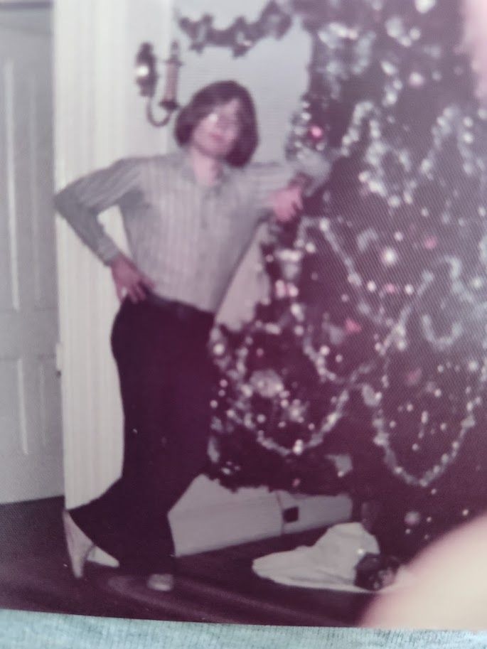 He's holding up the Christmas Tree!! Ha Ha