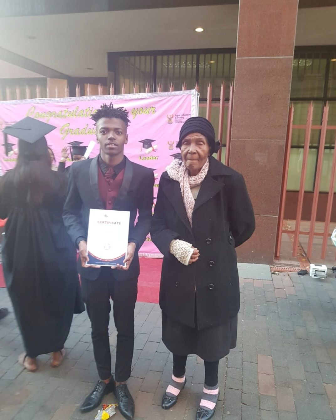Gogo with Mpilo (grandson) at his graduation.